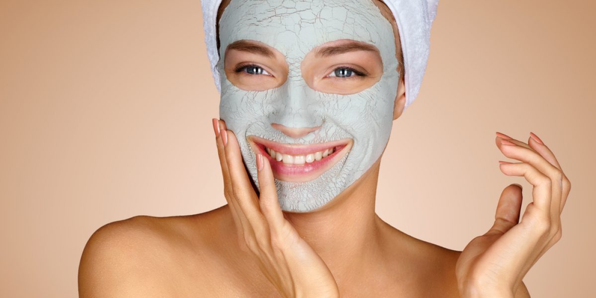 Happy,Woman,With,A,Clay,Mask.,Photo,Of,Attractive,Young